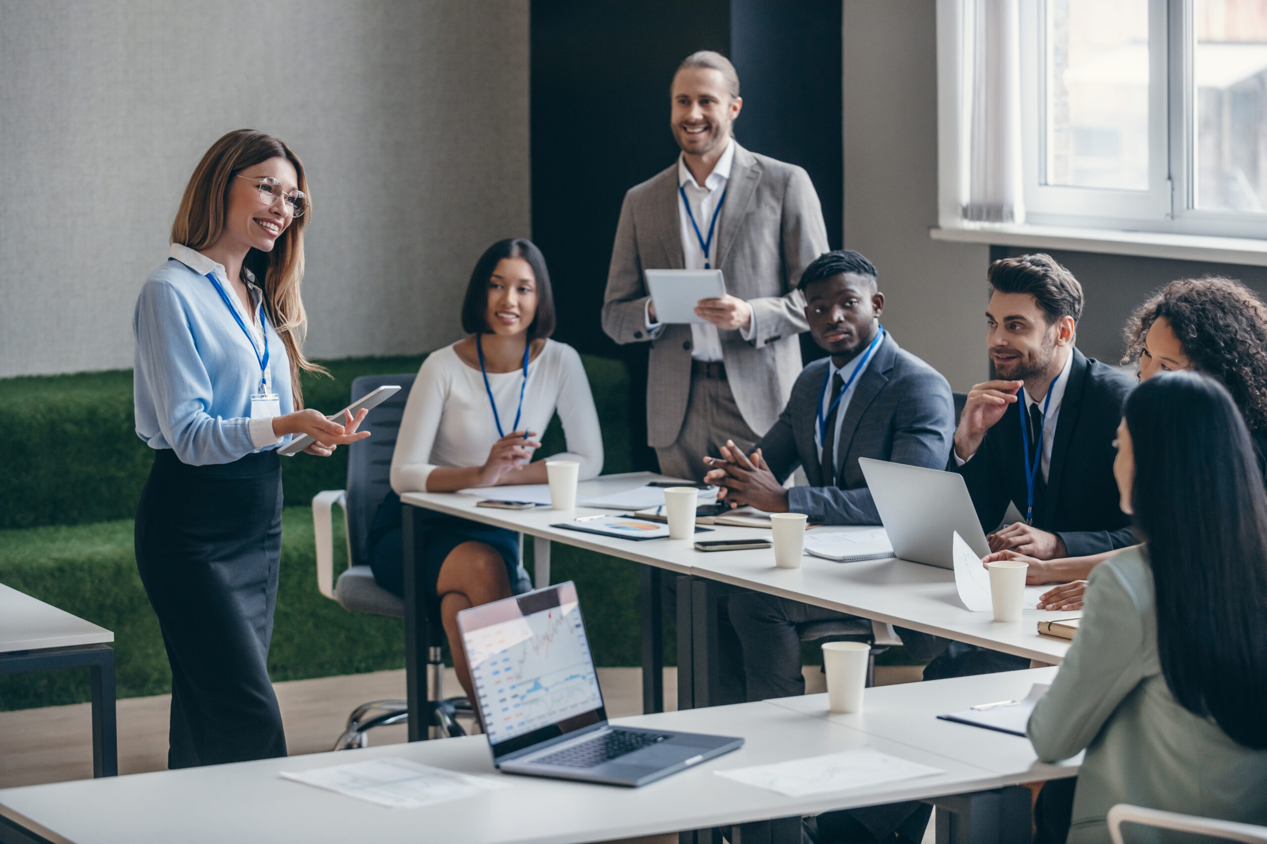 Happy female business expert talking to audience during a conference in convention center